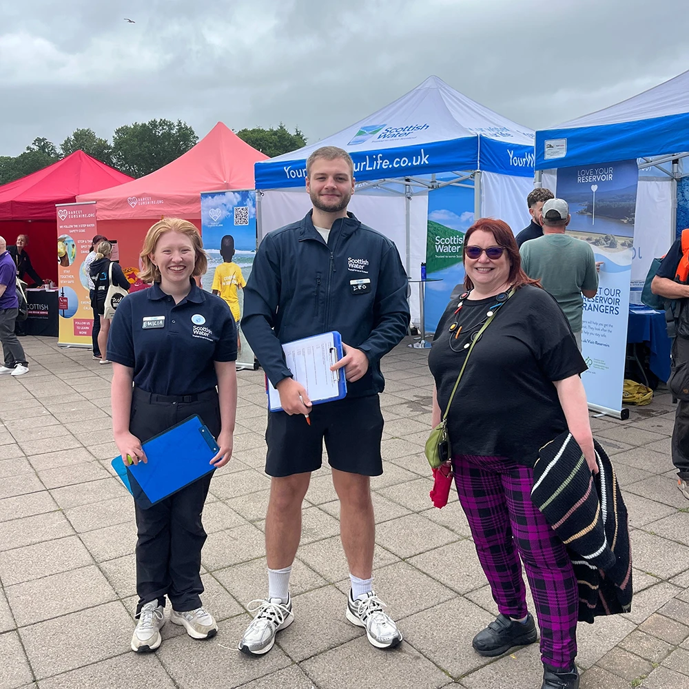 Clare Adamson MSP – Community Engagement Clare Adamson MSP’s team at an outdoor community event, standing in front of colourful tents and ready to engage with local residents.