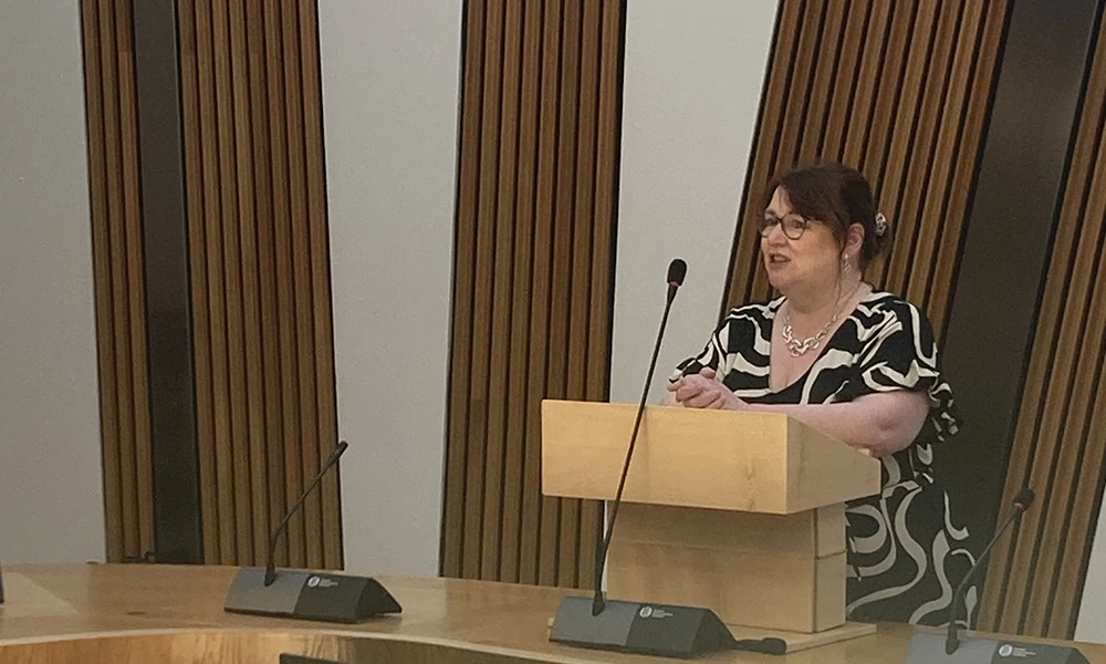 A podium in a formal setting with microphones, suitable for speeches or parliamentary updates.